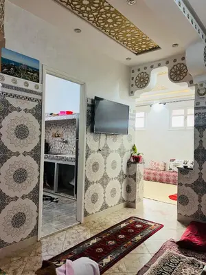 a living room with a flat screen tv on a wall at Angel 12 minutes from Marrakech airport in Marrakech