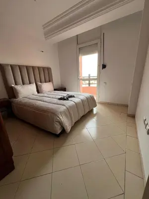 a bedroom with a large bed and a window at Calm & Cozy Studio with Balcony in Marrakech