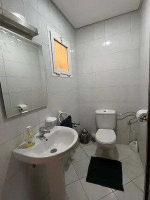 a white bathroom with a sink and a toilet at Calm & Cozy Studio with Balcony in Marrakech