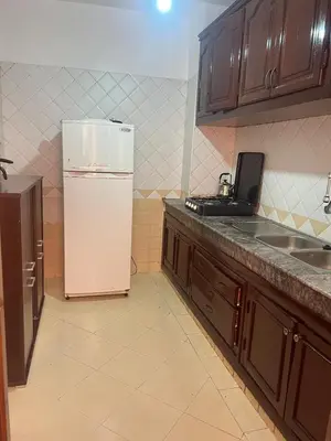 a kitchen with a white refrigerator and a sink at Calm & Cozy Studio with Balcony in Marrakech