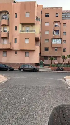 a car parked in front of a large building at Calm & Cozy Studio with Balcony in Marrakech