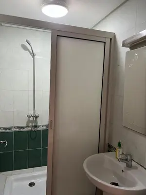 a bathroom with a shower and a sink and a tub at Calm & Cozy Studio with Balcony in Marrakech