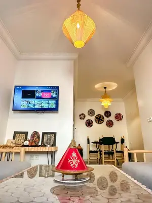 a living room with a red lamp on a table at A flat near the airport in Marrakech