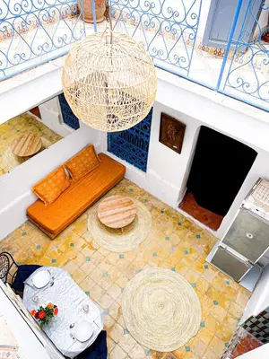 an overhead view of a room with a bench and a chandelier at Riad bleu 4 in Marrakech