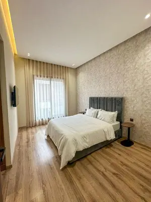a bedroom with a large bed and a large window at Villa Stayvi 1 Heated Pool Bliss in Marrakech
