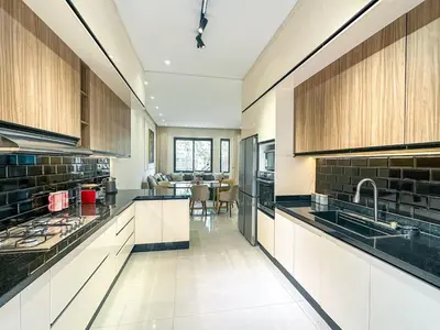 a large kitchen with white cabinets and a table at Villa Stayvi 1 Heated Pool Bliss in Marrakech