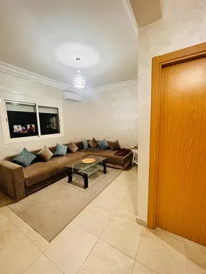 a living room with a couch and a table at Bright downtown apartment in Marrakech