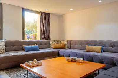 a living room with a couch and a table at Atelier Loft Oliver Palm Resort in Marrakech