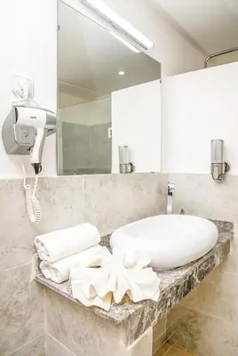a bathroom with a white sink and a mirror at Lux Oasis - Marrakech Center in Marrakech
