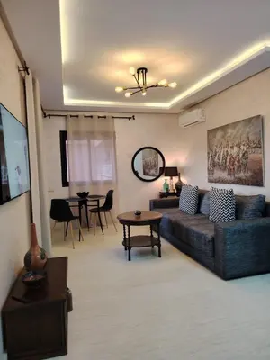 a living room with a couch and a table at Modern apartement in Hivernage in Marrakech