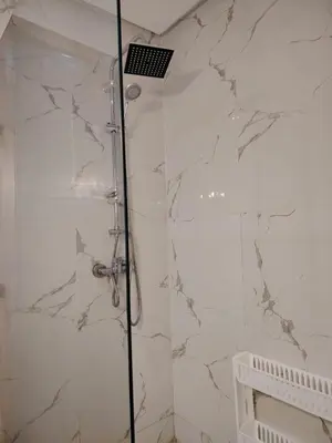 a bathroom with a shower with white marble at Modern apartement in Hivernage in Marrakech