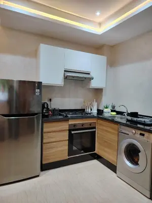a kitchen with a stainless steel dishwasher and a washer at Modern apartement in Hivernage in Marrakech