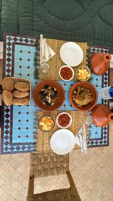 a table with plates and bowls of food on it at Riad Abrare in Marrakech