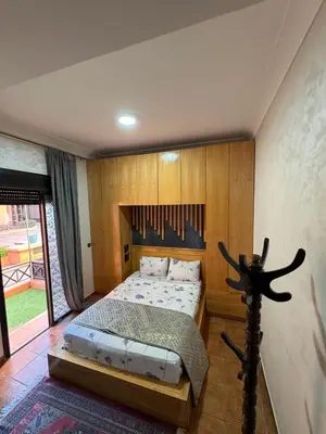 a bedroom with a bed with a wooden wall at Dream stay 5 swimming pools for family in Marrakech
