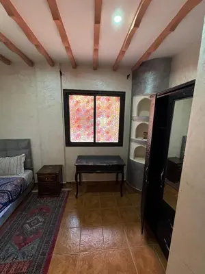 a living room with a bed and a window at Dream stay 5 swimming pools for family in Marrakech