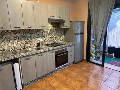 a kitchen with a sink and a refrigerator at Dream stay 5 swimming pools for family in Marrakech