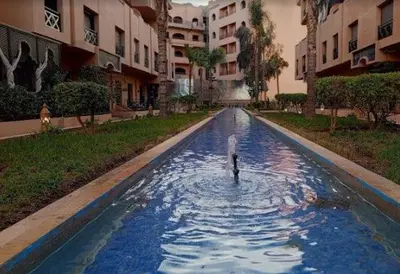 a person in a pool of water in a building at Dream stay 5 swimming pools for family in Marrakech