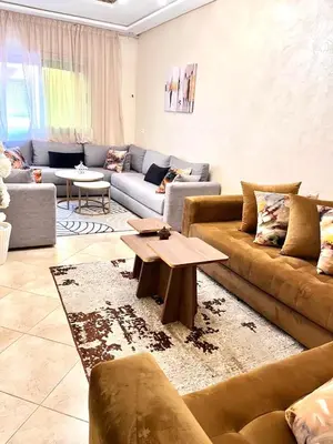 a living room with couches and a coffee table at Appartement Marrakech 2 chambres Residence al Manar in Marrakech