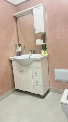 a bathroom with a white sink and a mirror at Appartement, Marrakech cosy & traditionnel in Marrakech