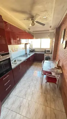 a large kitchen with a table and a ceiling at Appartement, Marrakech cosy & traditionnel in Marrakech