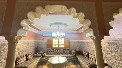a large room with a chandelier hanging from a ceiling at Appartement, Marrakech cosy & traditionnel in Marrakech
