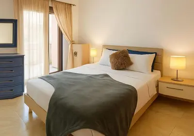 a bedroom with a large bed and a television at Appart Opera Prestige Détente Moderne in Marrakech