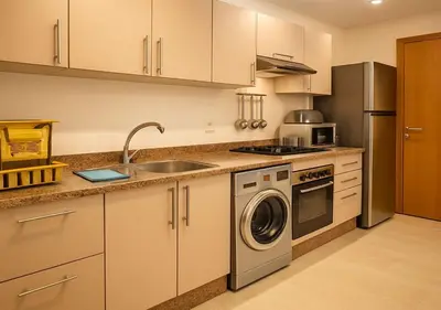 a kitchen with a sink and a washing machine at Appart Opera Prestige Détente Moderne in Marrakech