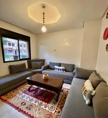 a living room with a couch and a coffee table at appartement à coté des palmeraies in Marrakech