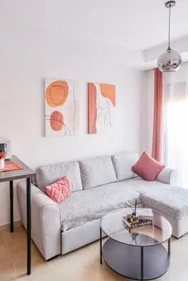 a living room with a couch and a table at Eva cosy - Clim, Wifi, Jardin à 10min de l'Aéroport in Marrakech