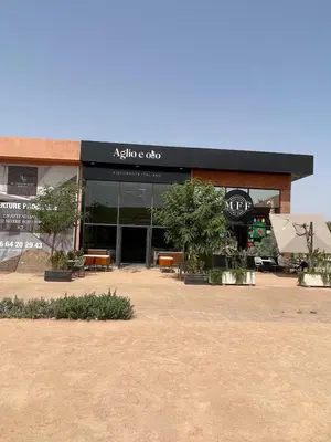 a building with a sign that reads akoya coda at Eva cosy - Clim, Wifi, Jardin à 10min de l'Aéroport in Marrakech