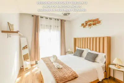a bedroom with a white bed with a large window at Maeva cosy - Clim, Wifi, Jardin à 10min de l'Aéroport in Marrakech