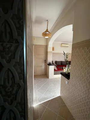 a hallway leading to a living room with a bed at Dali apartment in Marrakech
