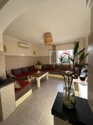 a living room with a couch and a table at Dali apartment in Marrakech