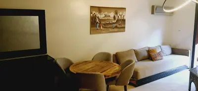 a living room with a couch and a table at Gueliz apartment 2 chambres Marrakech in Marrakech