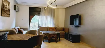 a living room with a couch and a table at Gueliz apartment 2 chambres Marrakech in Marrakech