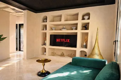 a living room with a couch and a tv at Private Riad Alemania in Marrakesh - Pool - Rooftop in Marrakech