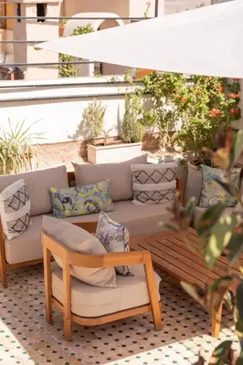 a couch sitting on top of a patio with pillows at Riad Dar Bousga in Marrakech