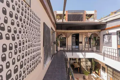 an external view of a building with a patterned wall at Riad Dar Bousga in Marrakech