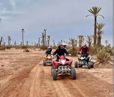 a group of people riding atvs on a dirt road at Appartement deux chambres a gueliz in Marrakech