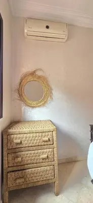 a room with a dresser and a mirror on the wall at Appartement deux chambres a gueliz in Marrakech
