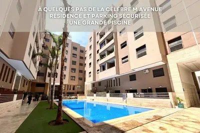 a apartment with a swimming pool in a building at Mama cosy - Clim, Wifi, Piscine en centre ville in Marrakech