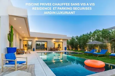 a villa with a swimming pool with blue chairs at Villa AZUR - Wifi, Piscine chauffée, Sans vis-à-vis in Marrakech