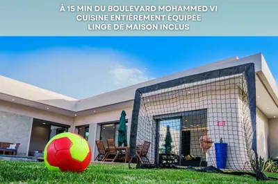 a soccer ball on the grass in front of a goal at Villa AZUR - Wifi, Piscine chauffée, Sans vis-à-vis in Marrakech