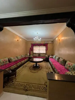 a living room with couches and a table at Appartement familiale et traditionnel in Marrakech