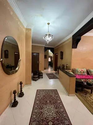 a large living room with a mirror and a rug at Appartement familiale et traditionnel in Marrakech