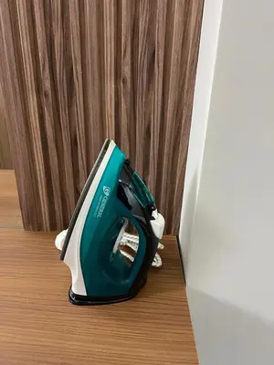 a green and white toaster sitting on a wooden floor at elite garden appartment in Marrakech