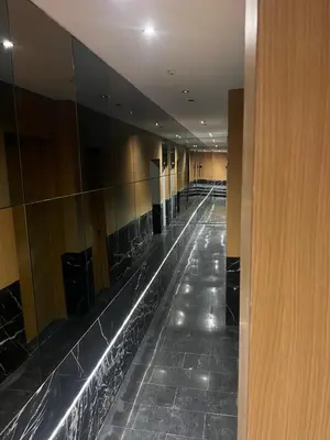 an empty hallway with a long row of mirrors at elite garden appartment in Marrakech