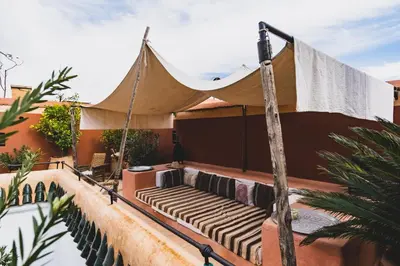 a hammock on the back of a house at Riad El Ayadi, Moorish villa in Marrakech