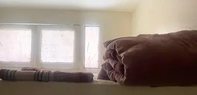 a bedroom with two windows and a pillow in front at Medina Marrakech Life in Marrakech