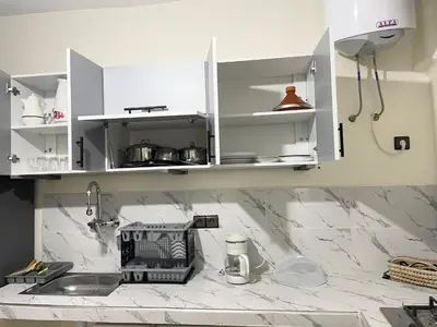 a kitchen with white cabinets and a sink at Medina Marrakech Life in Marrakech